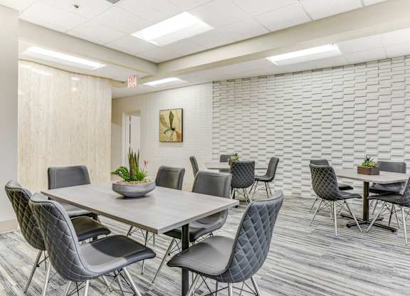 A conference room with a long table surrounded by chairs. at Academy at Drexel Apartments, Chicago, Illinois