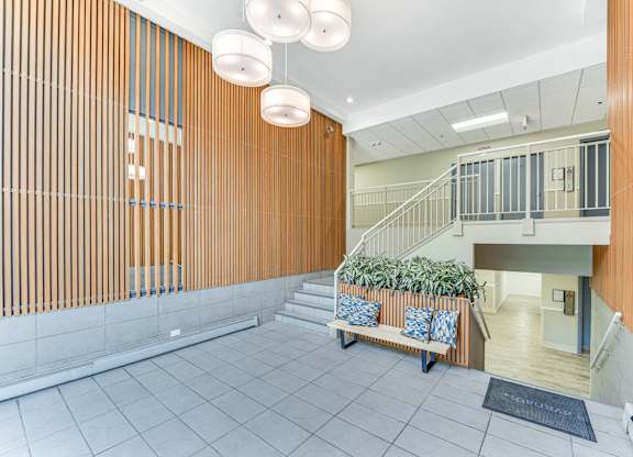 A wooden wall with a staircase in the background. at Academy at Drexel Apartments, Chicago, IL, 60637