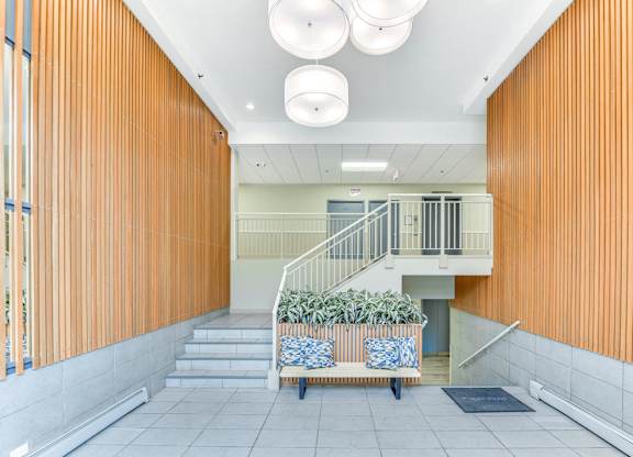 A staircase with a plant on the landing. at Academy at Drexel Apartments, Chicago, IL