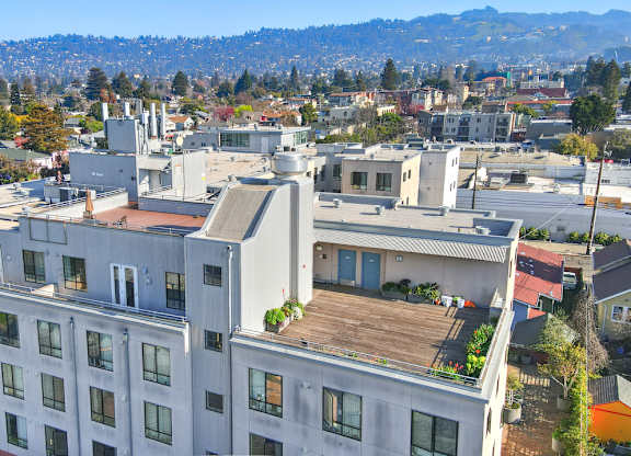 A large white building with a balcony overlooking a city. at Acton Courtyard, California