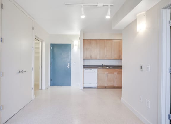A kitchen area with a white fridge and wooden cabinets. at Acton Courtyard, Berkeley, CA, 94703