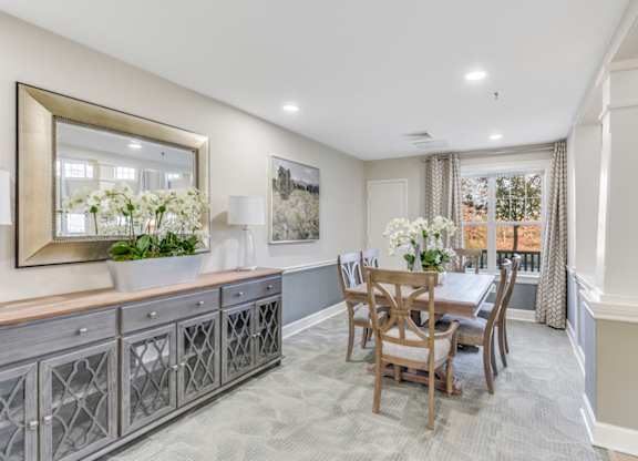 A dining room with a wooden table and chairs at Manor at Victoria Park,  Maryland