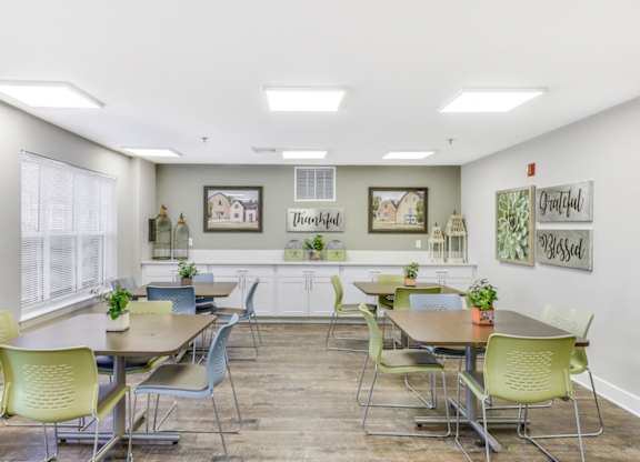 A conference room with a long table and chairs at Manor at Victoria Park,  Maryland, 20748