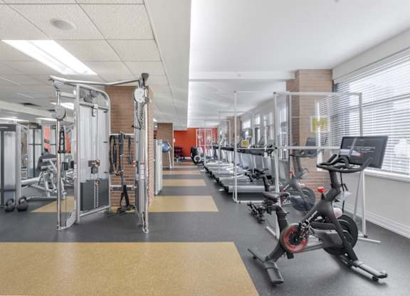 A gym with a variety of equipment including treadmills, weights, and exercise bikes. at Affinity at 2M, Washington
