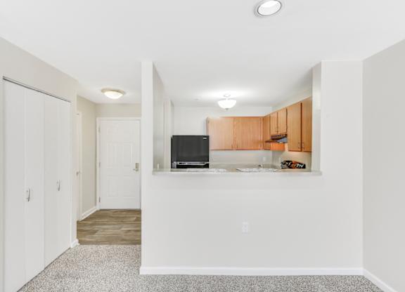 A room with a television and wooden cabinets at Manor at Victoria Park, Temple Hills, 20748