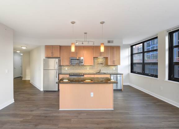A kitchen with a refrigerator, stove, and sink. at Affinity at 2M, Washington, Washington