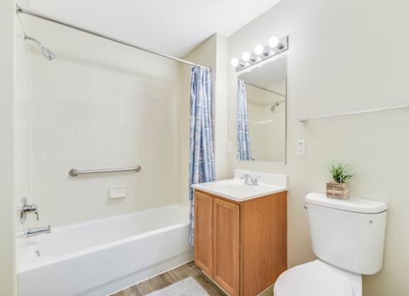 A white toilet sits next to a sink in a bathroom at Manor at Victoria Park,  Maryland, 20748