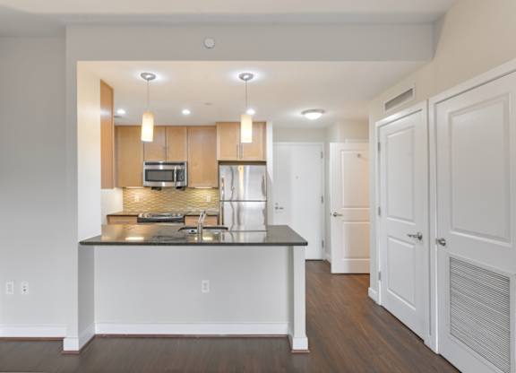 A modern kitchen with a center island and stainless steel appliances. at Affinity at 2M, Washington, DC, 20002