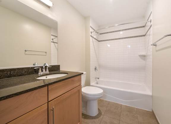 A bathroom with a toilet, sink, and bathtub. at Affinity at 2M, Washington, DC, 20002