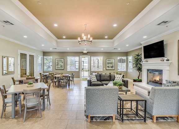 A spacious living room with a fireplace and a television.
