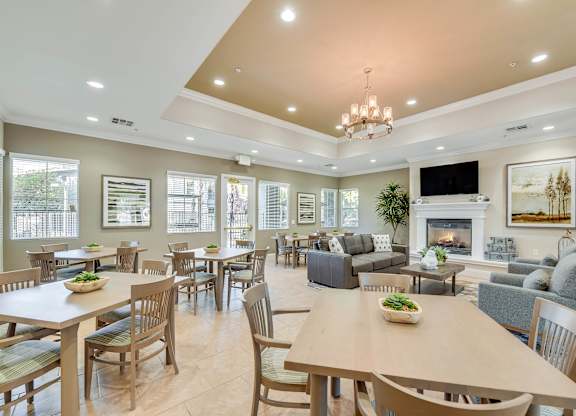 A spacious dining room with a large table and chairs.
