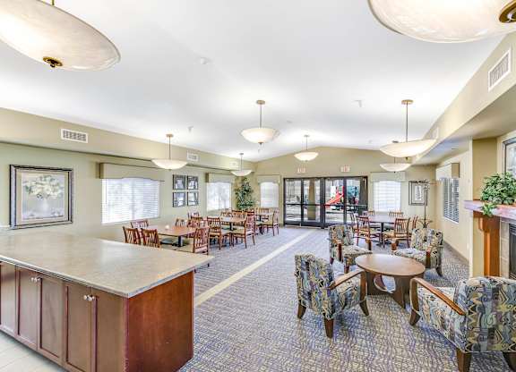 A large room with a bar and chairs at Yorba Linda Apartments, California