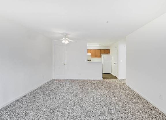 A room with a carpeted floor and a ceiling fan at Acclaim at Sterling in Sterling, VA