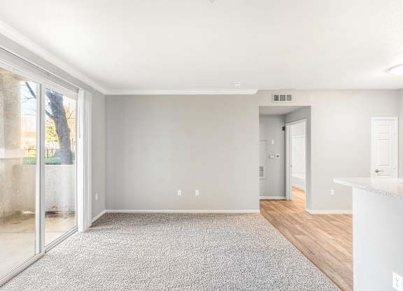 A spacious room with a carpeted floor and a white countertop.