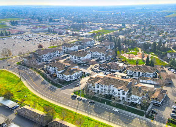 A bird's eye view of a residential area with houses and roads.