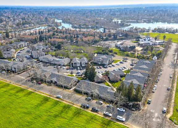 A bird's eye view of a residential area with houses and cars.