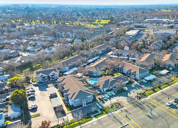 A bird's eye view of a residential area with houses and roads.
