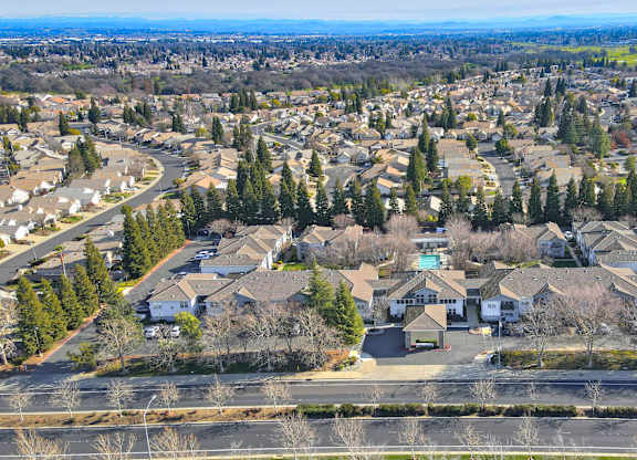A bird's eye view of a residential neighborhood with houses and trees.