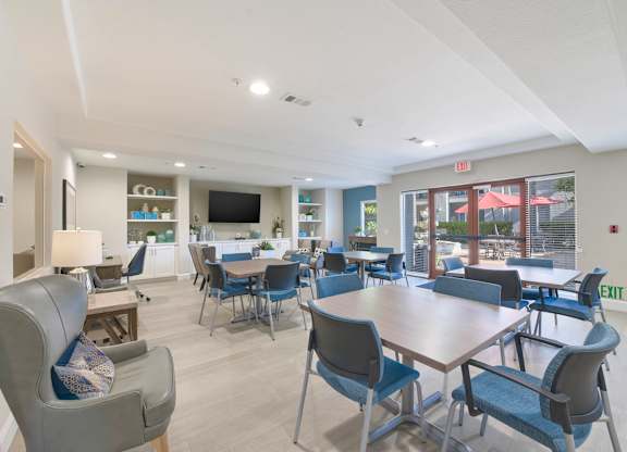 A conference room with a long table and chairs.