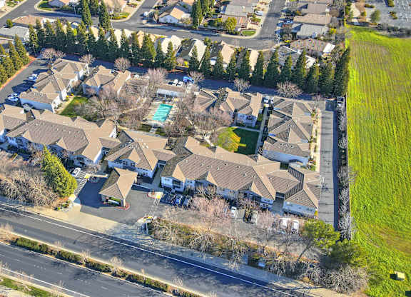 A bird's eye view of a residential area with houses and trees.
