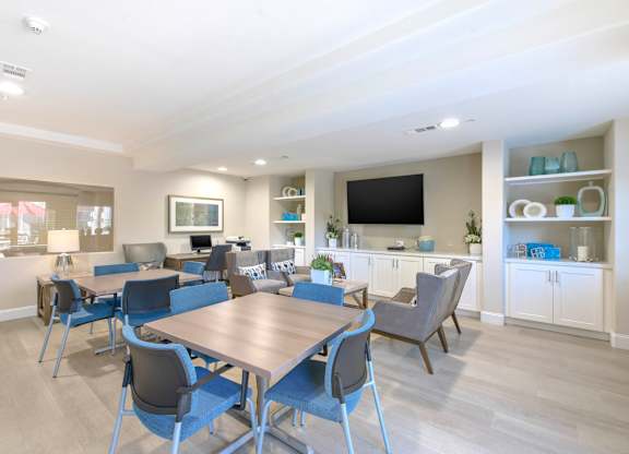 A dining room with a table and chairs.