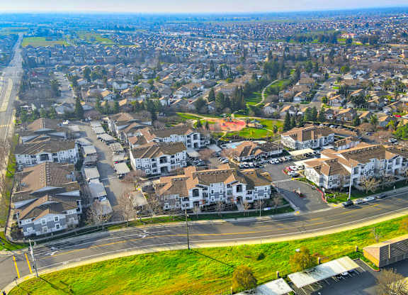 A bird's eye view of a residential area with houses and roads.