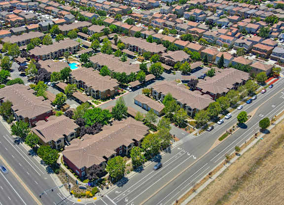 A bird's eye view of a residential area with houses and roads at Hurley Creek Apartment Homes, California