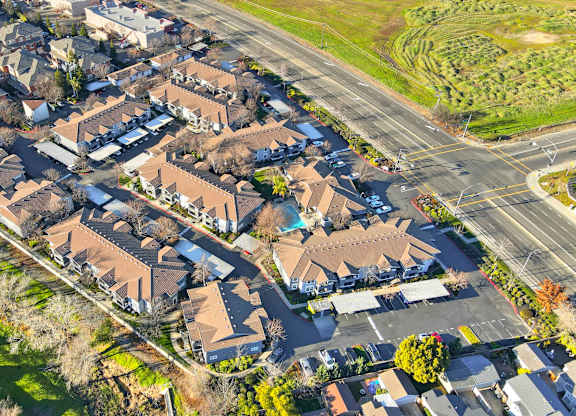 A suburban neighborhood with houses and a road.