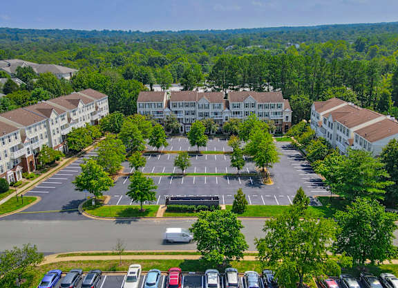 A parking lot with cars and a building in the background at Acclaim at Sterling in Sterling, VA