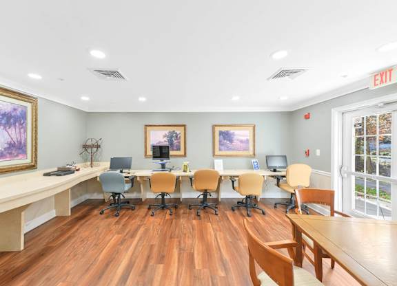 A conference room with a long table and chairs.