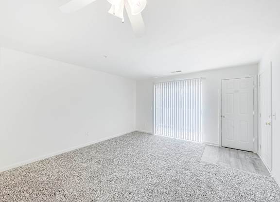 A spacious room with a carpeted floor and a ceiling fan at Acclaim at Sterling in Sterling, VA 20164
