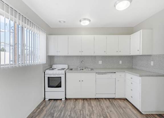 A kitchen with white appliances and cabinets. at Seaport Village, Long Beach, California