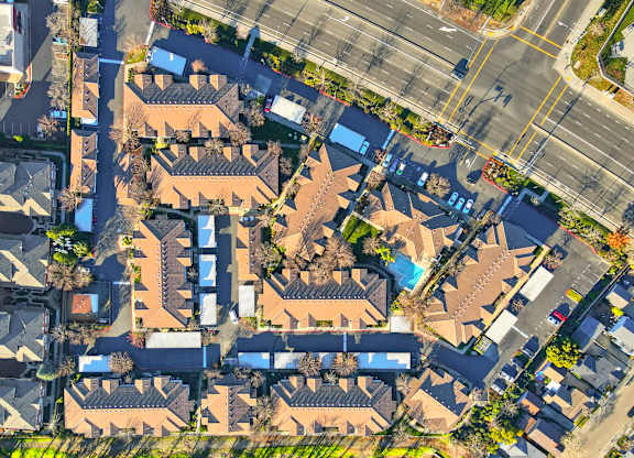 A bird's eye view of a residential area with houses and roads.