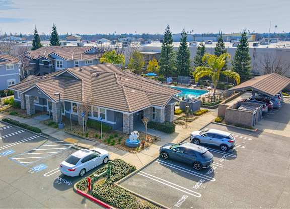 Aerial view of apartment buildings with parking at Corsair Park Senior Apartments, North Highlands, California