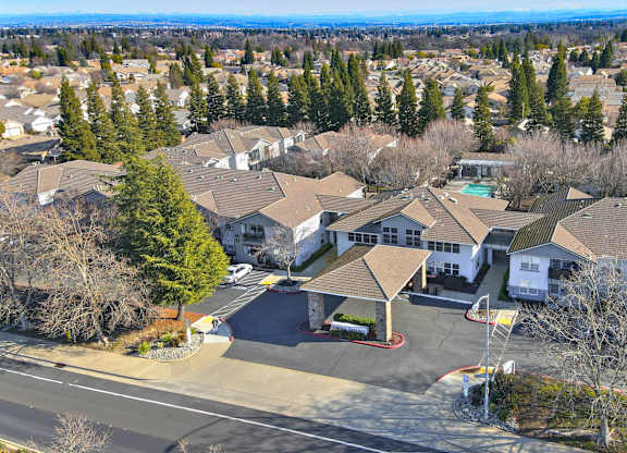 A bird's eye view of a residential area with houses and trees.