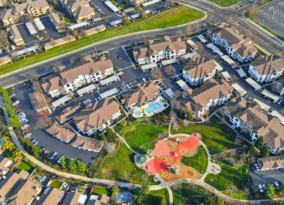 A bird's eye view of a residential area with houses and a playground.