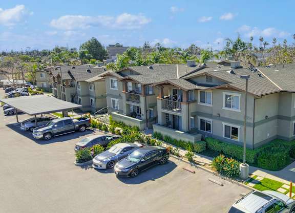 A row of houses with cars parked in front at Yorba Linda Apartments, Yorba Linda, CA