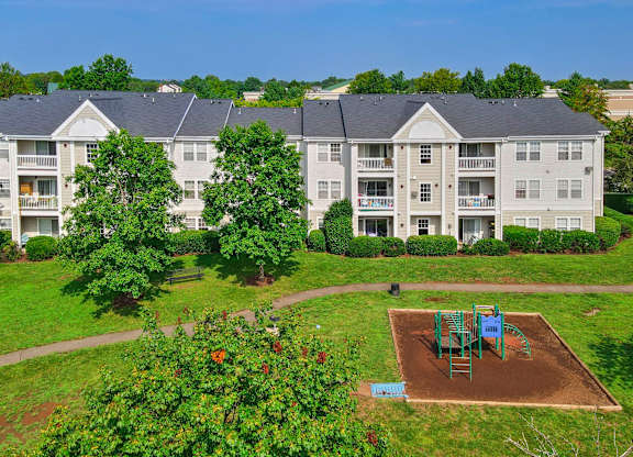 Apartment buildings with playground and landscaping at Acclaim at Ashburn Apartments, Ashburn, Virginia