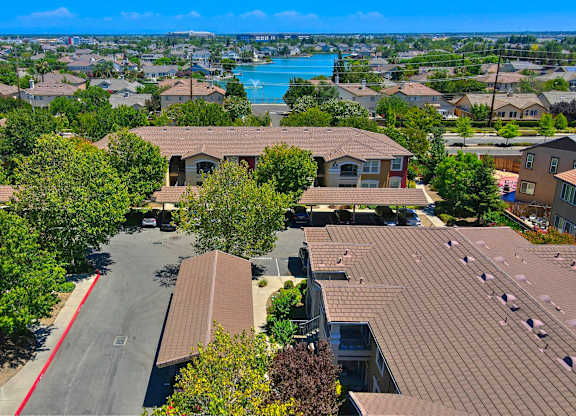 A view of a residential area with houses and a pool at Hurley Creek Apartment Homes, Sacramento, CA