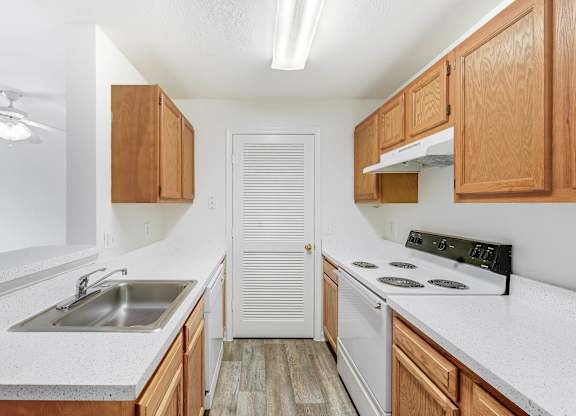 A kitchen with wooden cabinets and a white countertop at Acclaim at Sterling, Sterling, Virginia