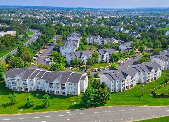 Aerial view of residential complex with green spaces at Acclaim at Ashburn Apartments, Virginia