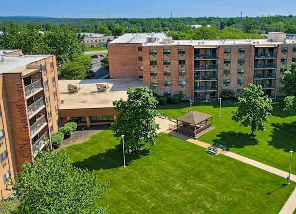 A large grassy area in front of a building at Menlo Manor Apartments, New Jersey
