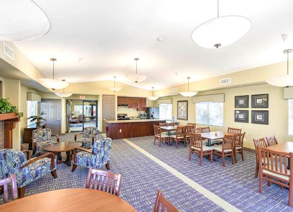 A large room with a fireplace and chairs at Yorba Linda Apartments, Yorba Linda, CA 92886