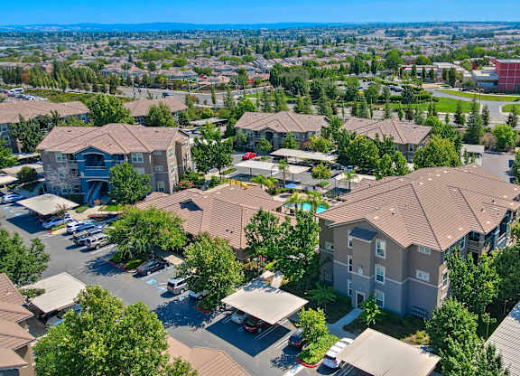 A bird's eye view of a residential area with houses and trees.