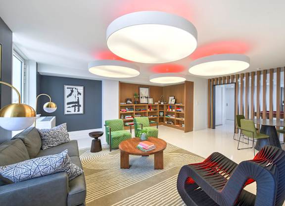 Community Lounge Area with a Grey Couch at 38 6th Ave Apartments, Brooklyn, NY