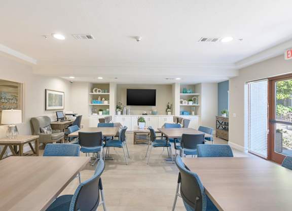A conference room with a long table and chairs.