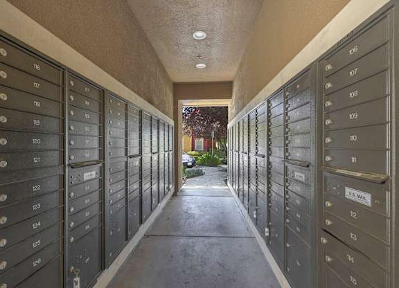 A long corridor of mailboxes with numbers 105 to 119 visible at Hurley Creek Apartment Homes, Sacramento, 95834