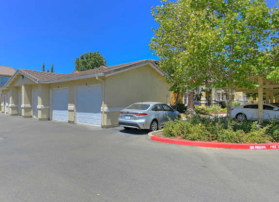 A parking lot with a car parked in front of a building at Hurley Creek Apartment Homes, Sacramento, CA
