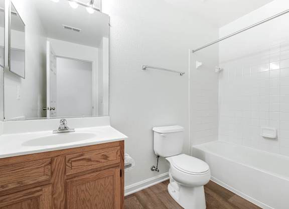 A white bathroom with a toilet, sink, and bathtub at Acclaim at Sterling, Sterling, Virginia