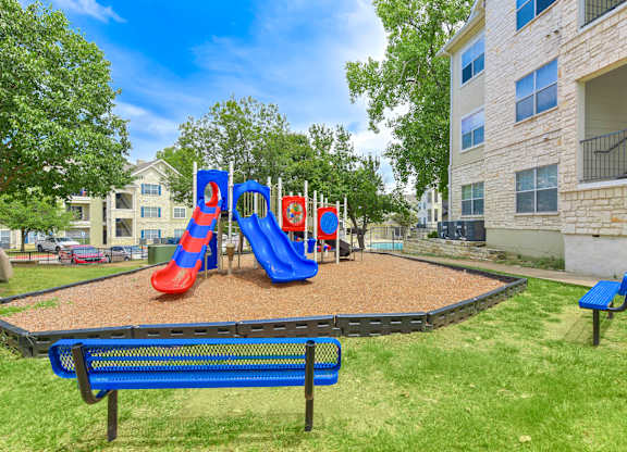 Playground with a blue slide at Acclaim at South Congress, Austin, TX